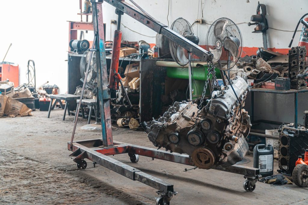 Detailed view of an engine lift in an industrial workshop setting.