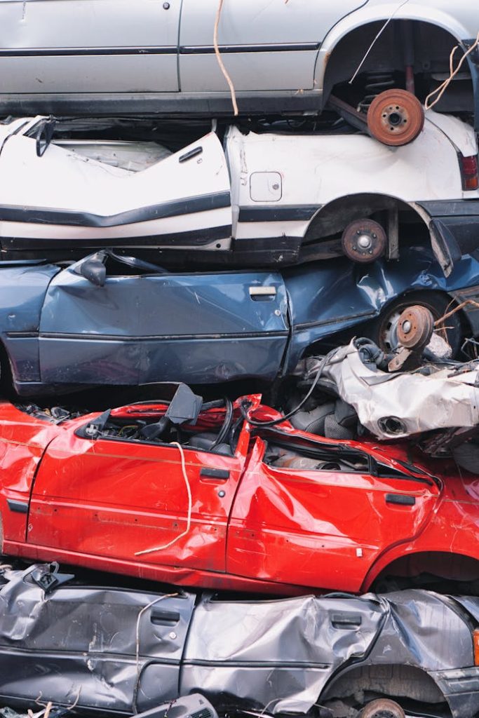 Vertical shot of crushed cars stacked at a junkyard in Bern, Switzerland.